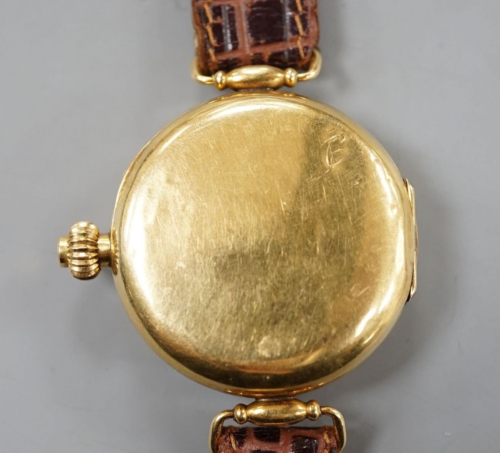 A gentleman's early 20th century 18k single button chronograph manual wind wrist watch, with enamelled Arabic dial and two subsidiary dials, with swivel lugs, on a later strap